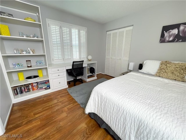 bedroom featuring dark wood-type flooring and a closet