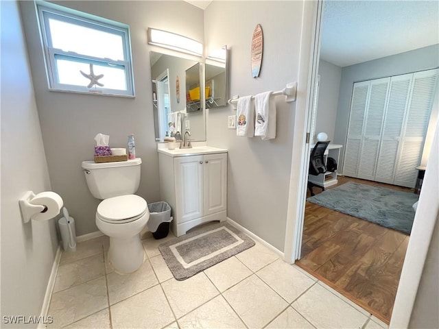 bathroom with tile patterned floors, vanity, and toilet