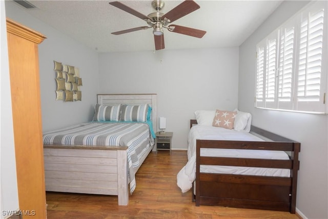 bedroom featuring ceiling fan and hardwood / wood-style floors