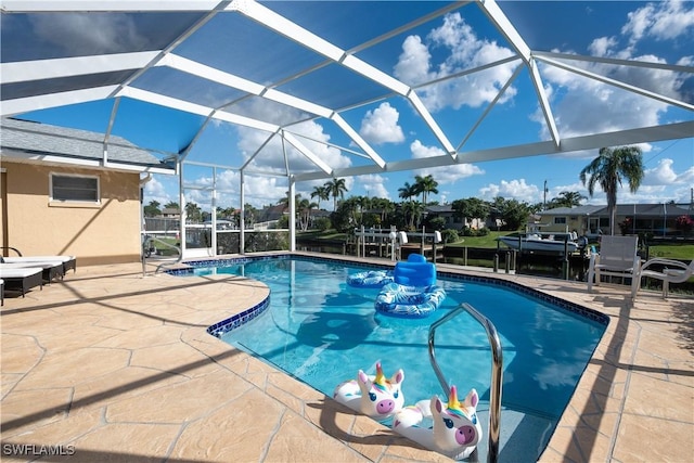 view of swimming pool with a lanai and a patio