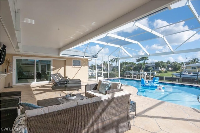 view of swimming pool with outdoor lounge area, a lanai, and a patio