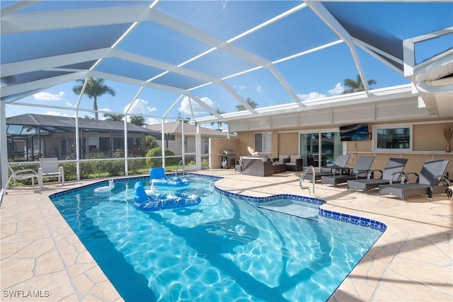 view of swimming pool featuring area for grilling, a patio, and glass enclosure