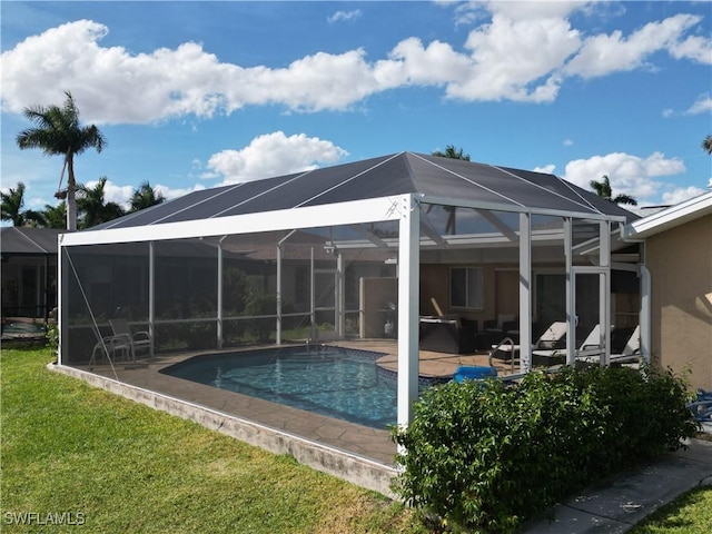 view of pool featuring glass enclosure and a patio area