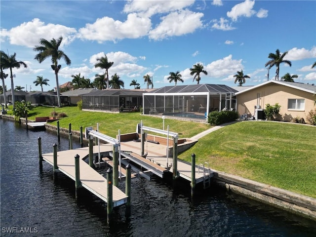 dock area featuring glass enclosure, a yard, and a water view