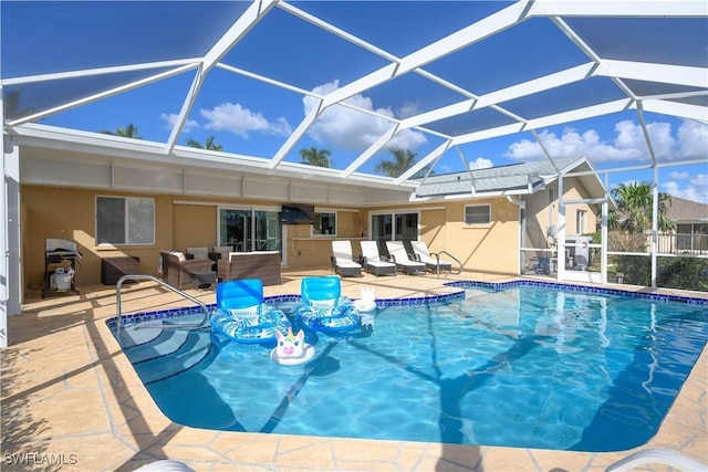 view of pool with a lanai, outdoor lounge area, and a patio area