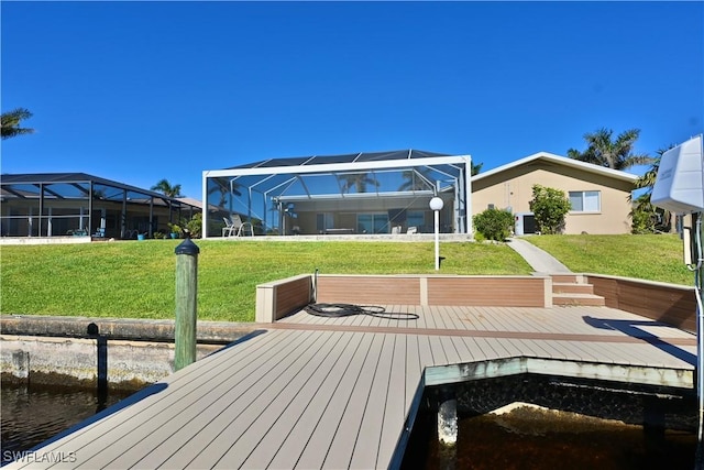 back of property featuring a yard, a water view, and glass enclosure