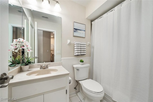 bathroom featuring tile patterned floors, vanity, and toilet