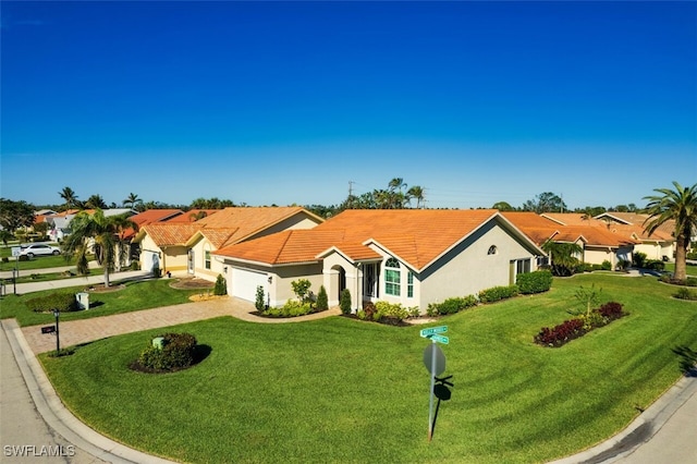 mediterranean / spanish-style house with a garage and a front yard