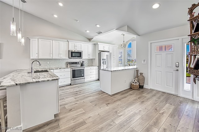 kitchen featuring white cabinetry, sink, stainless steel appliances, tasteful backsplash, and kitchen peninsula