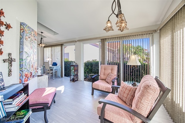 sunroom featuring a chandelier