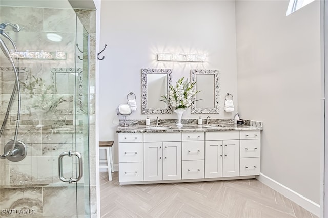 bathroom with vanity, a shower with shower door, and parquet flooring