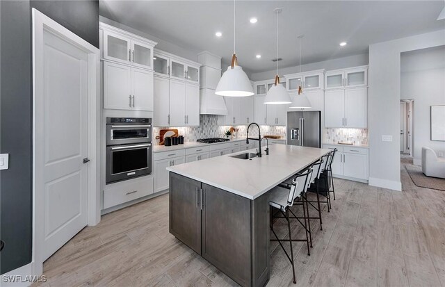 1845 Verada Ct, Naples, FL 34120 - kitchen with custom range hood, stainless steel appliances, sink, a center island with sink, and hanging light fixtures
