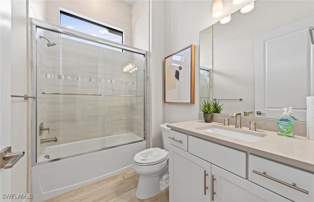 1845 Verada Ct, Naples, FL 34120 - full bathroom with vanity, toilet, and bath / shower combo with glass door