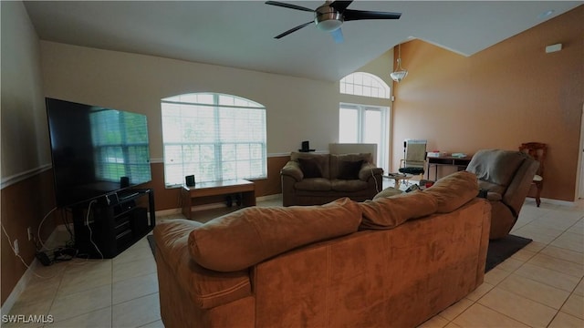 tiled living room with ceiling fan and vaulted ceiling