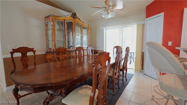 dining space with light tile patterned floors and ceiling fan