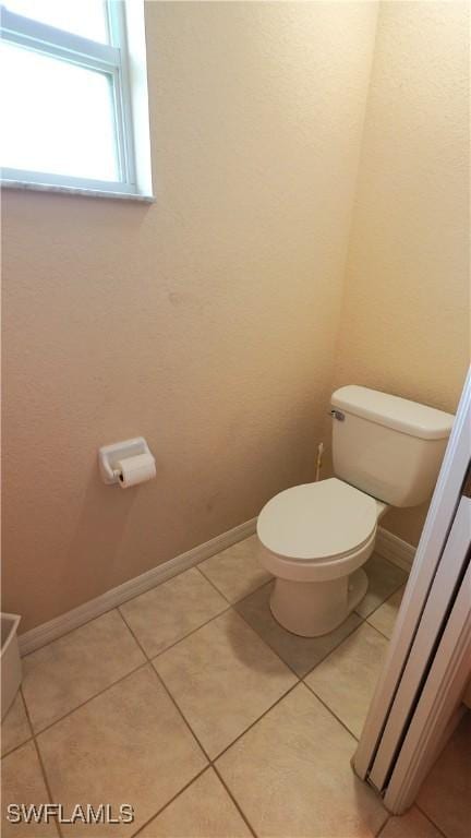 bathroom featuring tile patterned flooring and toilet