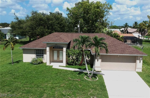 view of front of home with french doors, a garage, and a front lawn