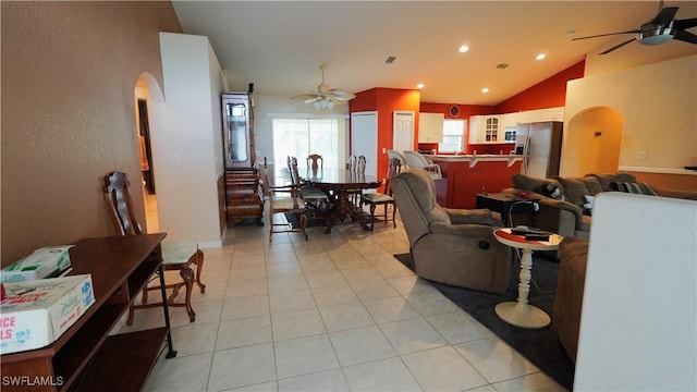 tiled living room featuring ceiling fan and lofted ceiling