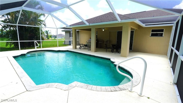 view of pool with a lanai, ceiling fan, and a patio area