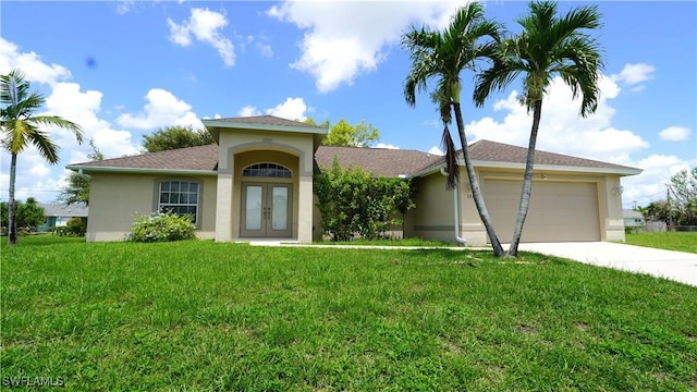 view of front facade featuring a front lawn, a garage, and french doors