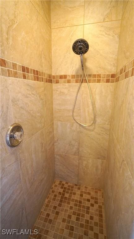 bathroom with tiled shower