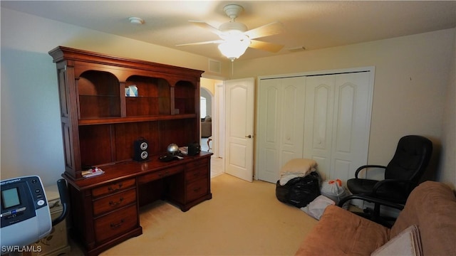 carpeted home office with ceiling fan