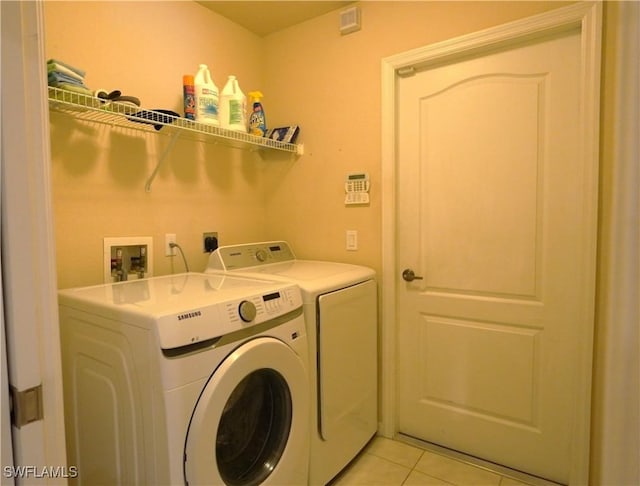 washroom featuring washer and dryer and light tile patterned floors