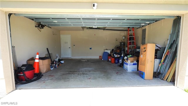 garage with electric panel and a garage door opener