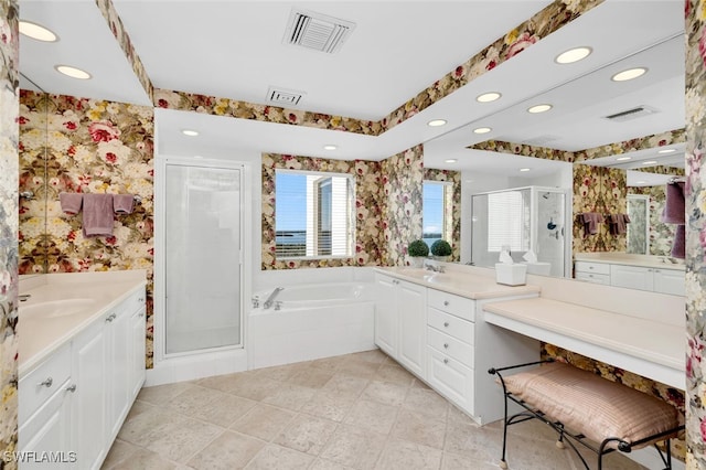 bathroom with separate shower and tub, vanity, and a healthy amount of sunlight