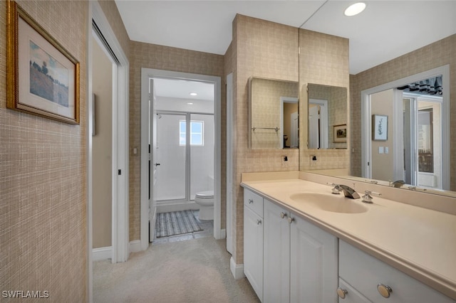 bathroom with a shower, vanity, and toilet