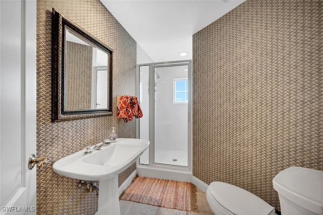 bathroom with toilet, a shower with shower door, and tile patterned flooring