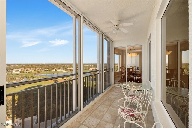 sunroom featuring ceiling fan