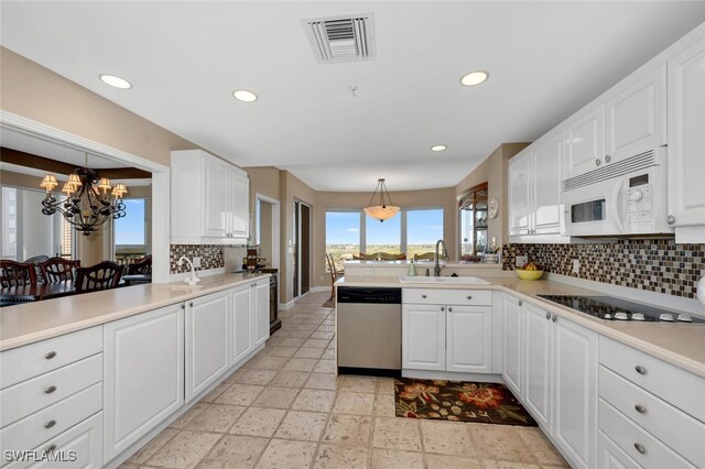 kitchen featuring sink, hanging light fixtures, black electric cooktop, dishwasher, and white cabinets