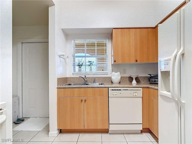 kitchen featuring sink, light tile patterned floors, and white appliances