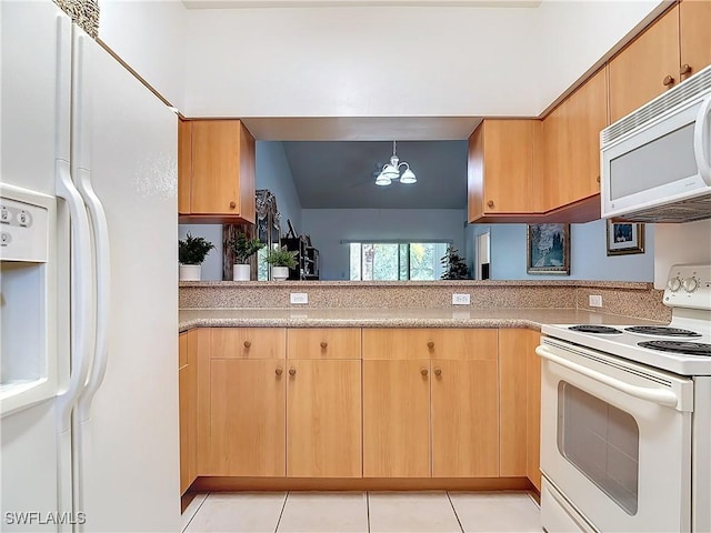 kitchen with hanging light fixtures, a notable chandelier, white appliances, light brown cabinetry, and light tile patterned floors