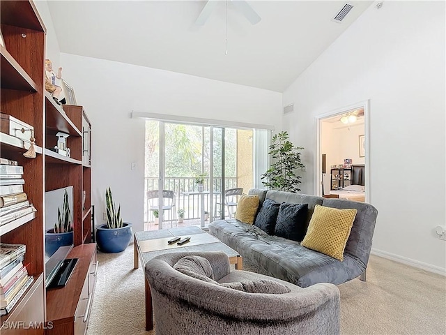 living room with ceiling fan, light colored carpet, and lofted ceiling