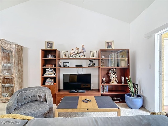 living room featuring carpet and lofted ceiling