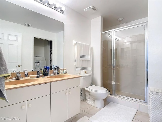 bathroom with tile patterned flooring, vanity, walk in shower, and washing machine and clothes dryer