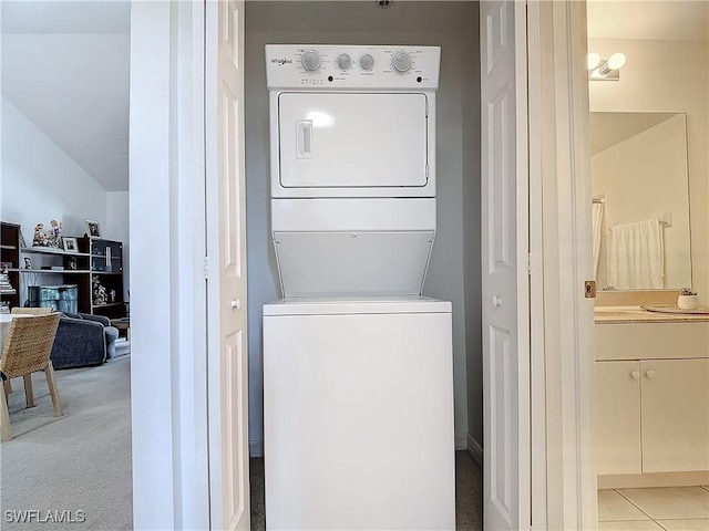 laundry area featuring light colored carpet and stacked washer / dryer