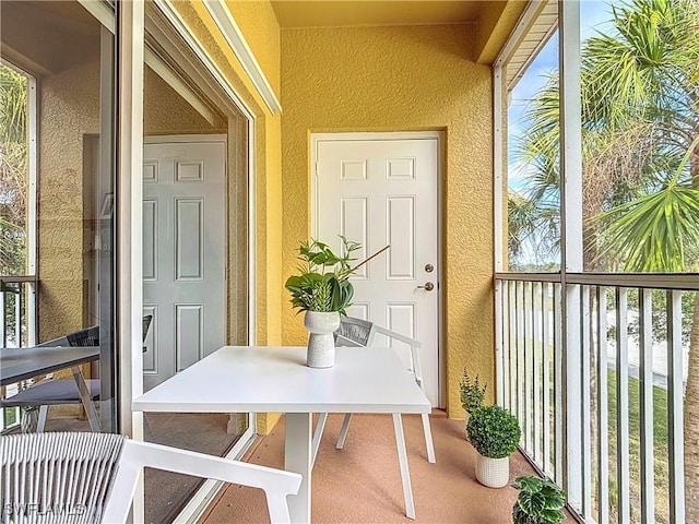 view of exterior entry with a balcony