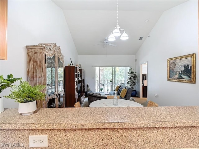 interior space with ceiling fan with notable chandelier