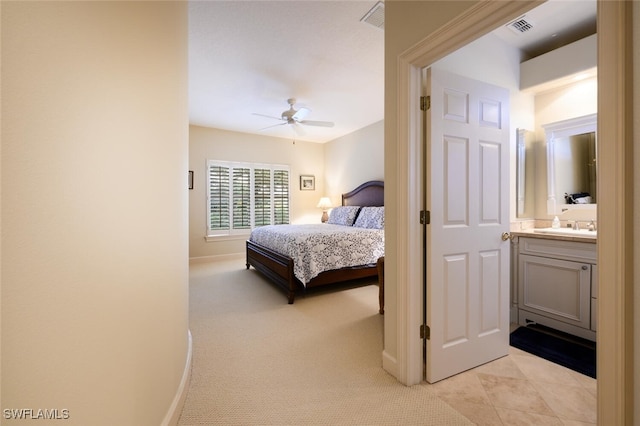 bedroom with light colored carpet, ceiling fan, and sink