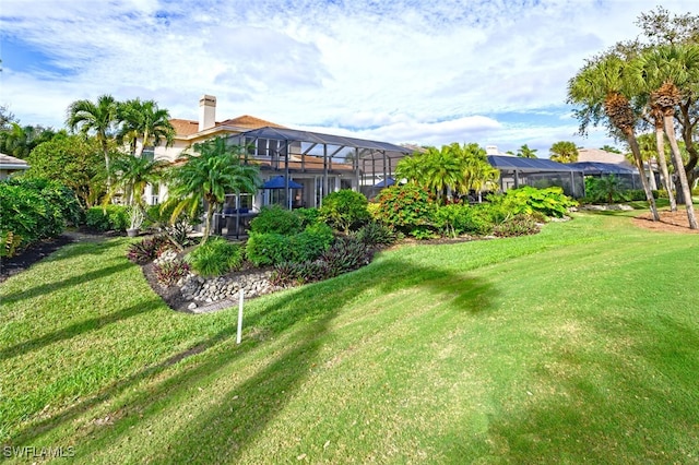 view of yard with glass enclosure