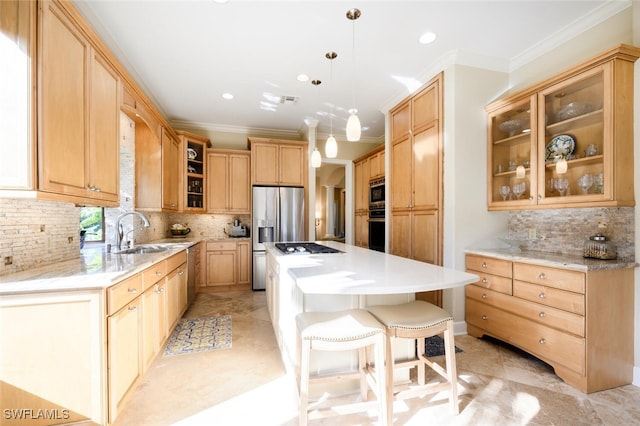 kitchen with sink, stainless steel appliances, backsplash, pendant lighting, and a kitchen island