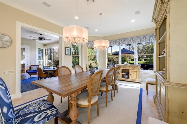 dining space with ceiling fan with notable chandelier and ornamental molding