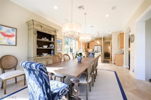 dining area with a notable chandelier and crown molding