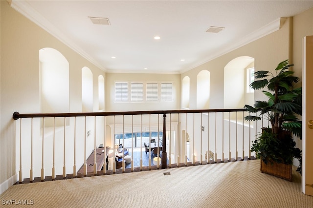 corridor with crown molding and carpet floors