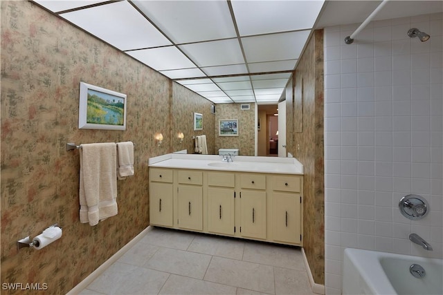 bathroom with tile patterned flooring, vanity, and tiled shower / bath