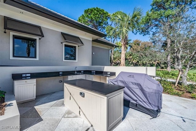 view of patio featuring grilling area, sink, and area for grilling