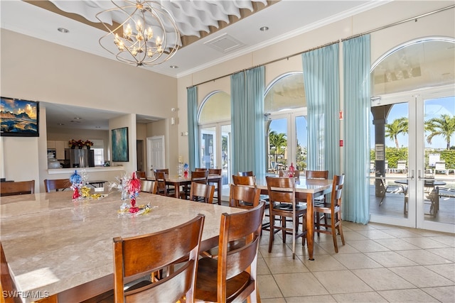 dining space with a wealth of natural light, french doors, a notable chandelier, and light tile patterned flooring